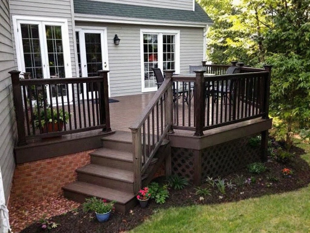 Skilled craftsman mastering a contemporary style deck installation in the area of Quincy, MA.